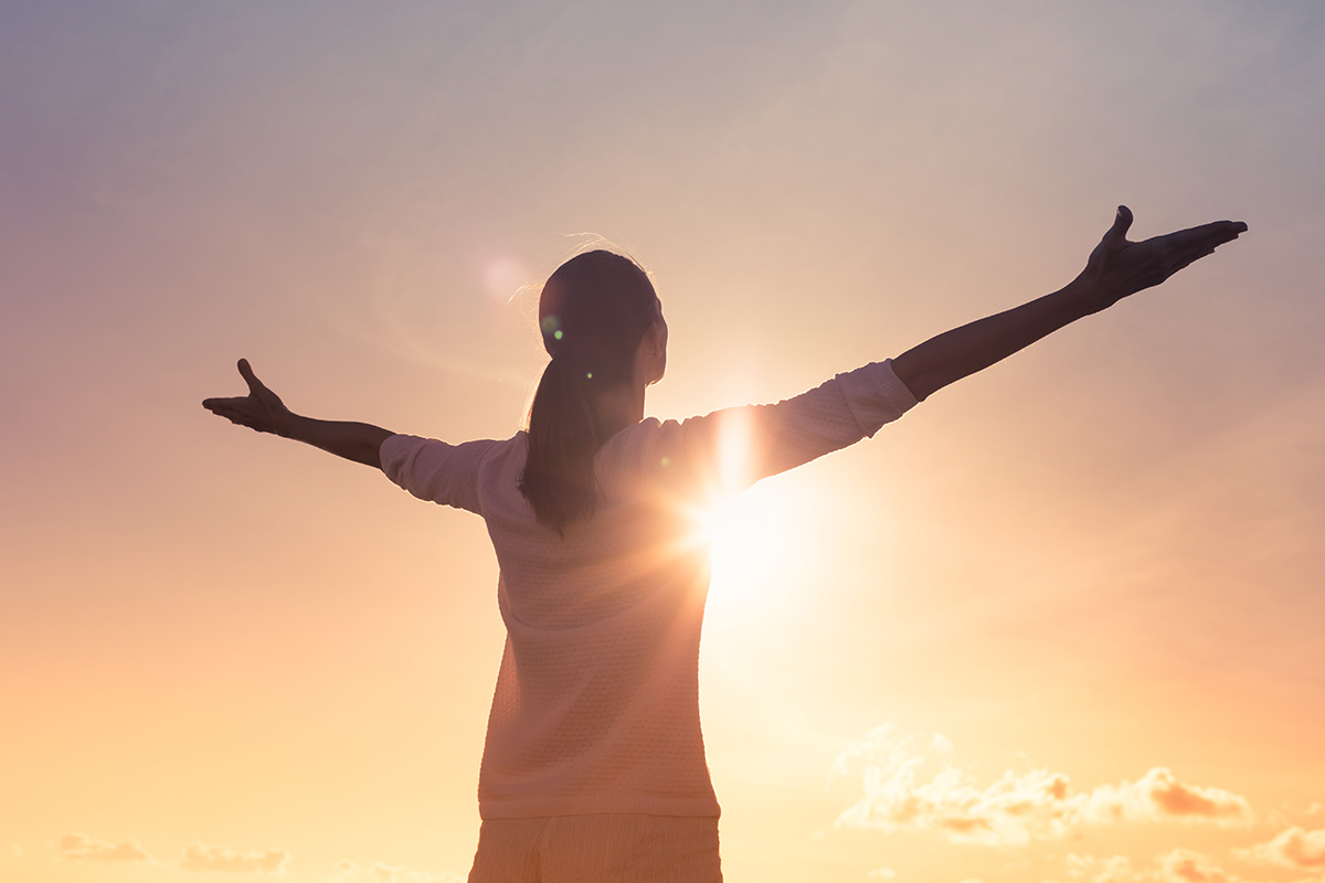 young woman experiencing spirituality at lakeview