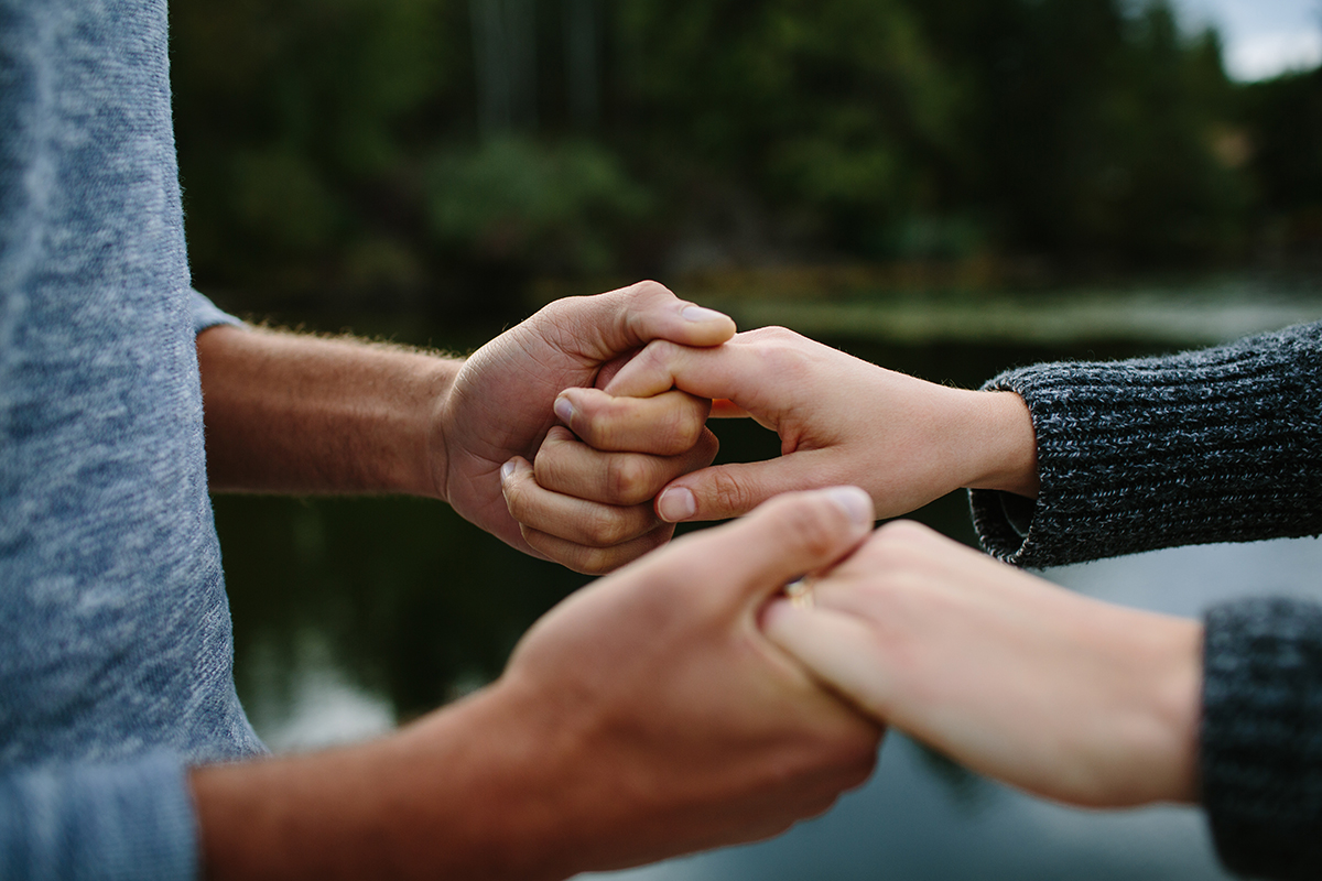 two people holding hands as they learn how to help a loved one after drug rehab