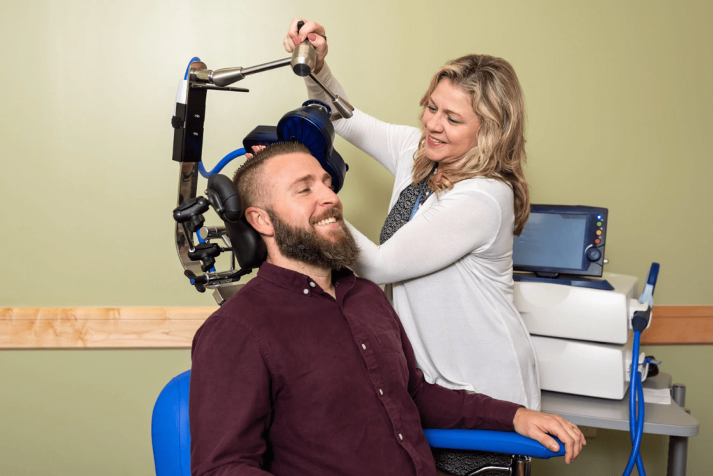 Man receiving TMS therapy from woman at lakeview health center