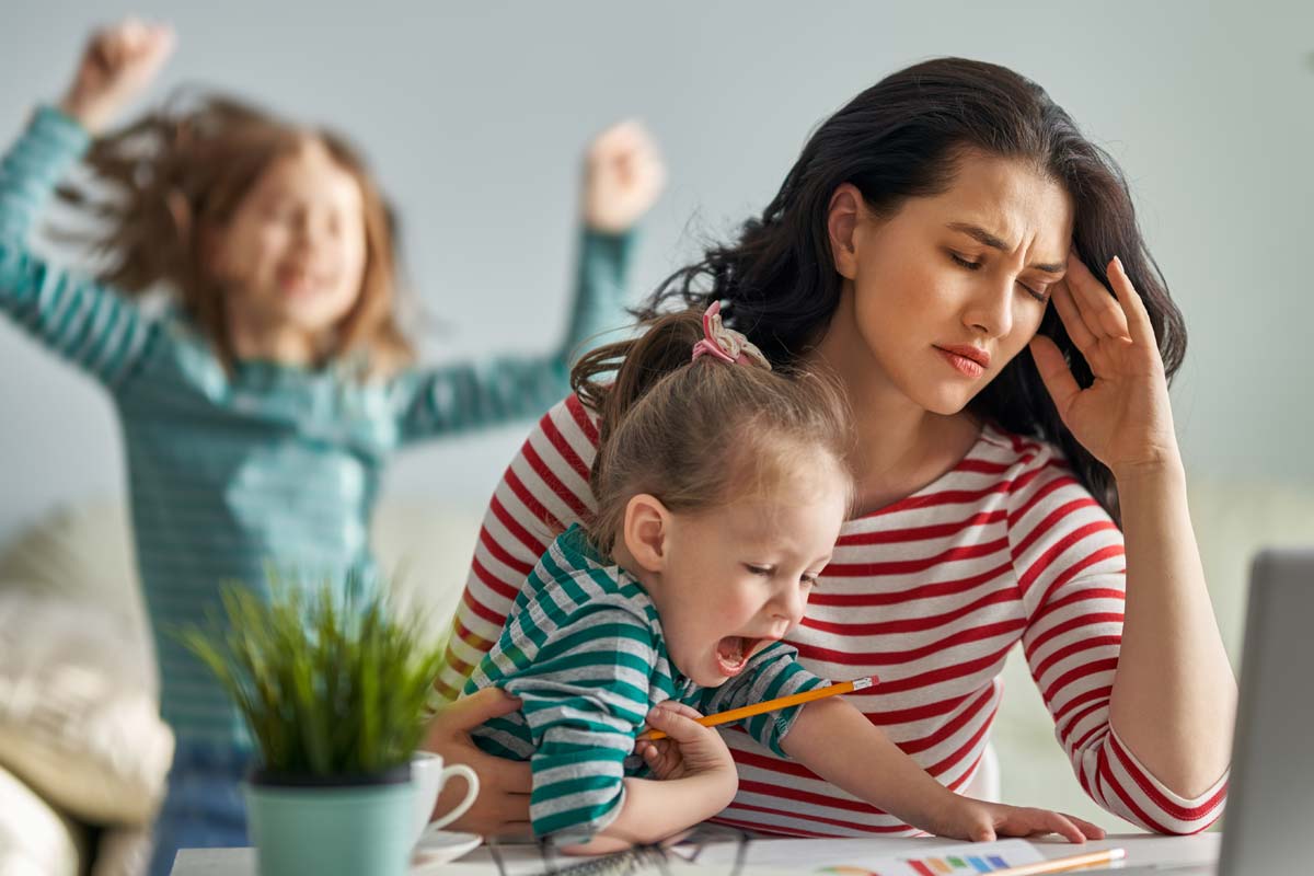 dangers of mommy drinking culture, mother with headache enduring screaming children