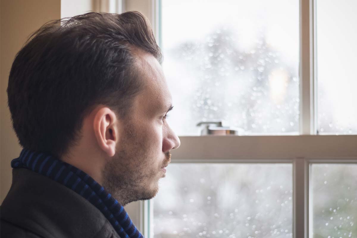 is drinking rubbing alcohol dangerous, man stares out window