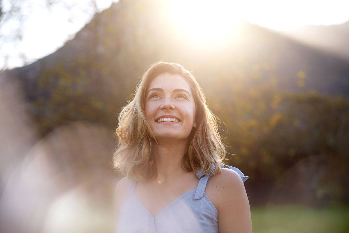 definition of sobriety, woman smiling outdoors with sunshine