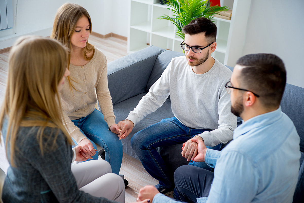 circle at group therapy holding hands after learning what to expect during residential treatment