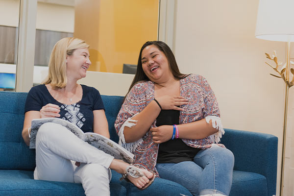 two women laughing in women's rehab program