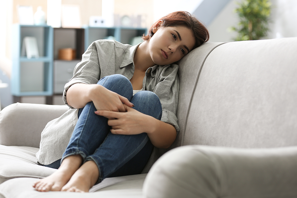 teen on couch struggling with binge drinking